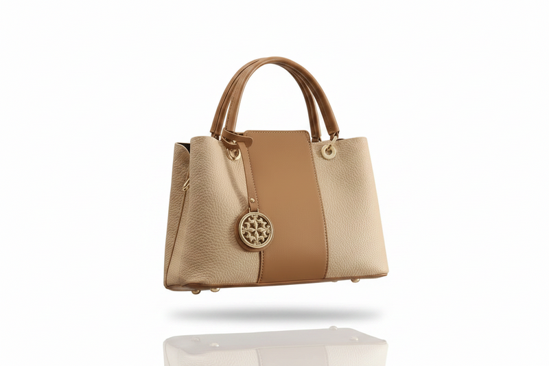 Two-tone khaki and tan leather top handle handbag with front medallion and metal feet