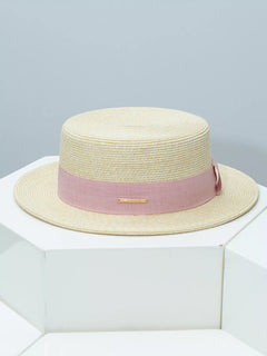 Beige straw boater hat with blush pink ribbon band and gold bar detail