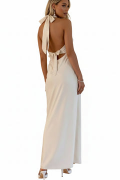 White halter-neck sleeveless maxi dress with open back and tie bow