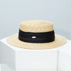 Straw boater hat with black ribbon band and beige woven brim