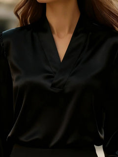 Satin V-neck long-sleeve blouse in black with V-neckline and front seam detail.