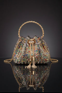 Rhinestone bucket crossbody bag in multicolor with gold-toned trim and chain straps