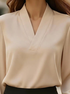 Khaki V-neck long sleeve satin blouse close-up of V-neckline and shoulder seams