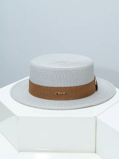 Light gray straw boater hat with brown ribbon band and gold bar detail