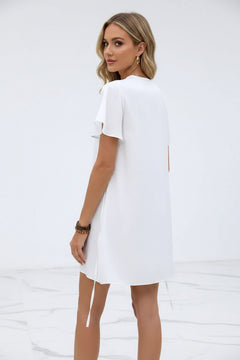 White satin mini dress with flutter sleeves and V-neck; back view