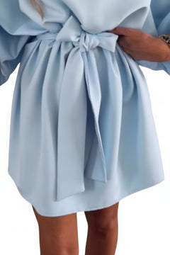 Light blue tie-waist mini dress close-up of bow and pleated skirt