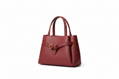 Burgundy leather top-handle handbag with gold-tone hardware and front buckle strap