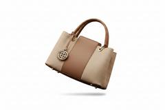 Two-tone khaki and tan leather top handle handbag, side view with front medallion and feet