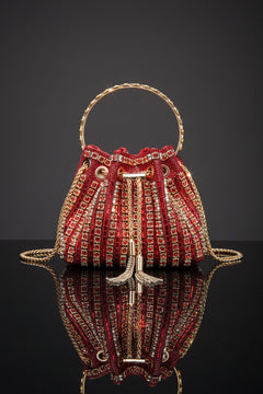 Rhinestone bucket crossbody bag in red with gold-toned trim and chain straps
