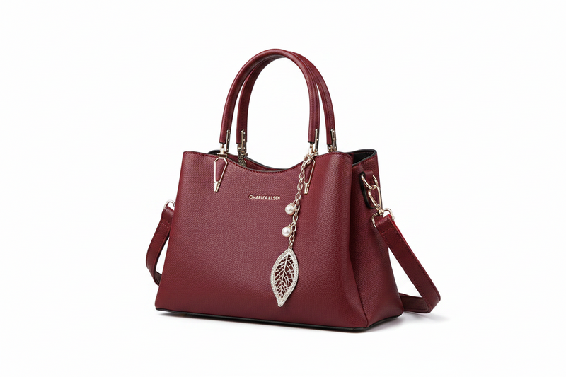 Red leather top-handle handbag with strap, gold hardware, leaf charm