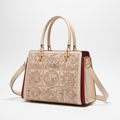 Apricot leather handbag with embossed front design, top handles, and crossbody strap