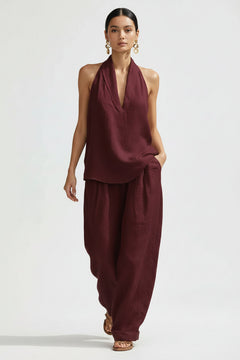 Burgundy halter neck top and wide-leg pants set with draped V neckline