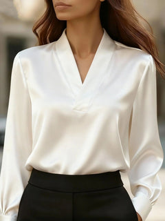 White V-neck long sleeve satin blouse with wrap-style front and gathered sleeve cuffs
