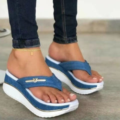 Blue platform toe-post sandals with gold logo bar and white thick sole trim.