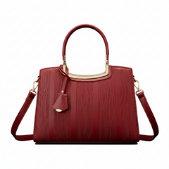 Red leather handbag with curved top handle, gold hardware, and shoulder straps