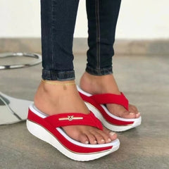 Red platform toe-post sandals with gold logo bar and white thick sole edging.
