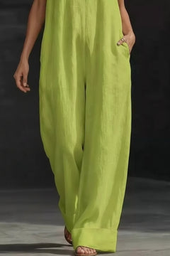 Lime green wide-leg jumpsuit with halter V-neck and flowy, wide trouser legs