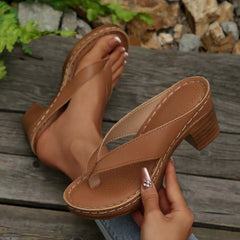 Tan toe-post block-heel sandals with perforated footbed, thong strap, and stitched edge.
