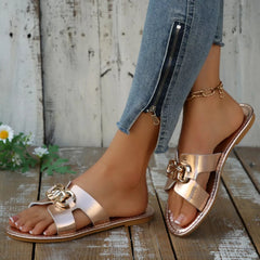 Champagne metallic open-toe sandals with wide strap and gold-tone buckle decor.