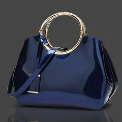 Indigo glossy handbag with wide strap and gold-toned ring handle