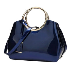 Indigo glossy handbag with gold ring handle and crossbody strap