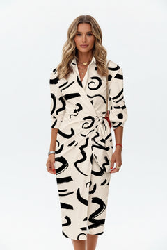 Cream printed collared shirt dress with waist tie and three-quarter sleeves.