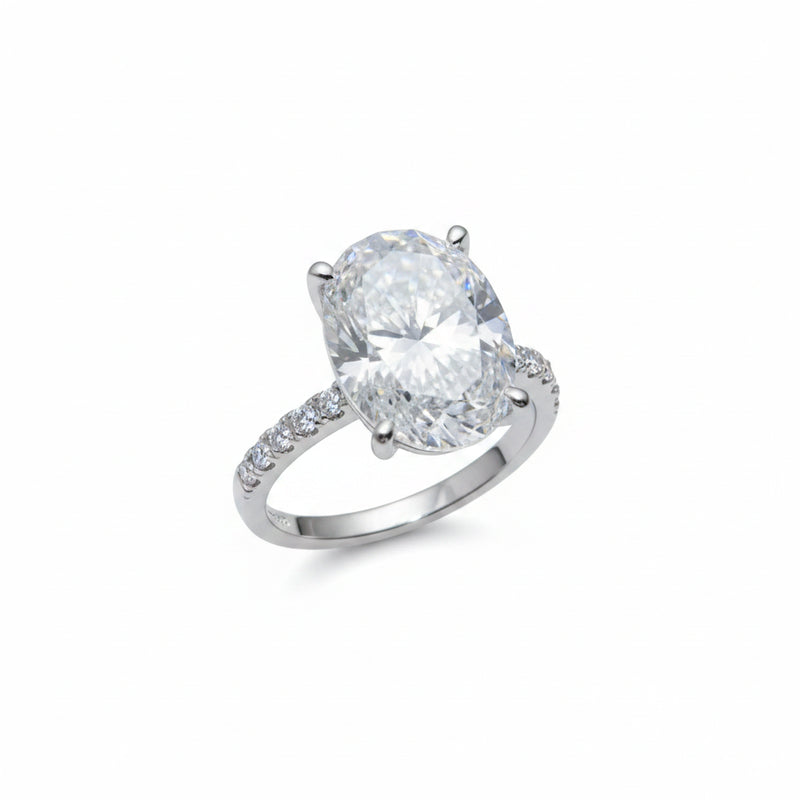 Sterling silver moissanite ring with round center stone and pavé band