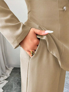 Beige blazer-and-pants set close-up: front button and side seam details.