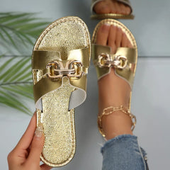 Gold metallic open toe sandals with front buckle decor and textured strap upper
