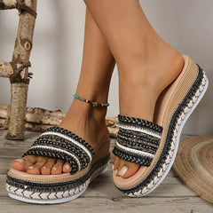 Black open-toe platform sandal, side view, woven striped straps with studded edge