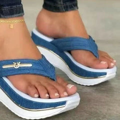 Blue platform toe-post sandals with front gold logo bar and white stripe accents.