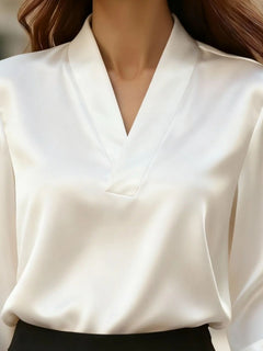 Satin V-neck long-sleeve blouse in white with V-neckline and structured front seam.
