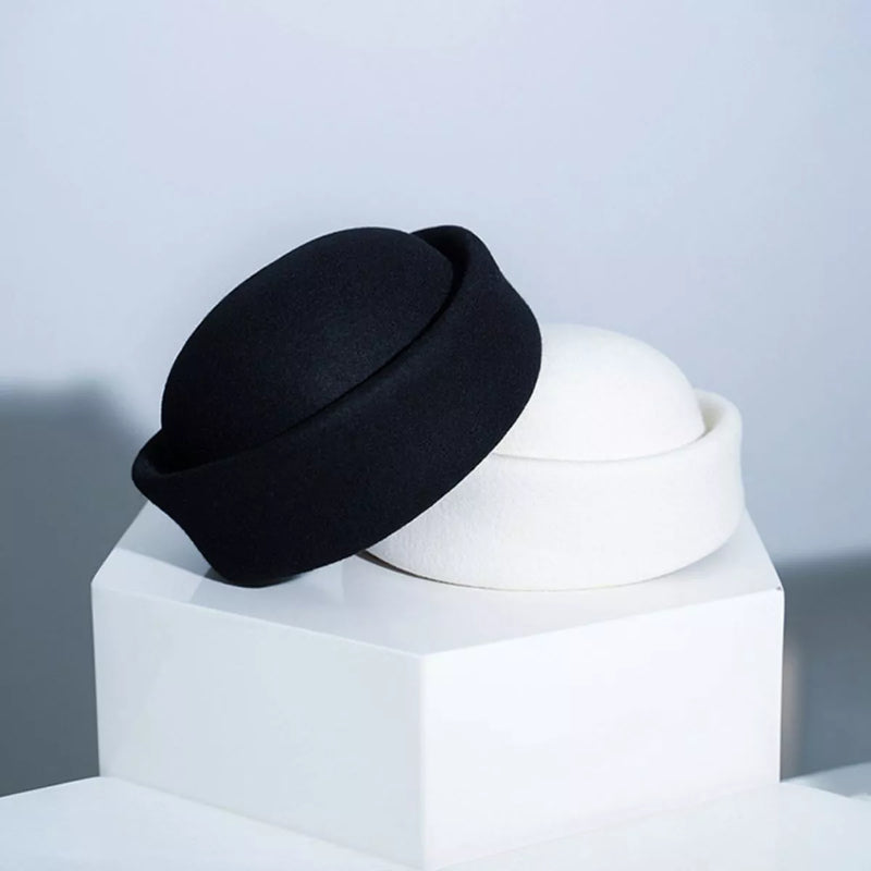 Black wool pillbox hat with flat crown and short brim