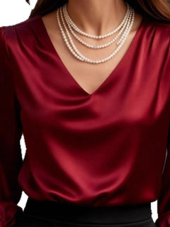 Red satin V-neck puff sleeve blouse, close-up of neckline