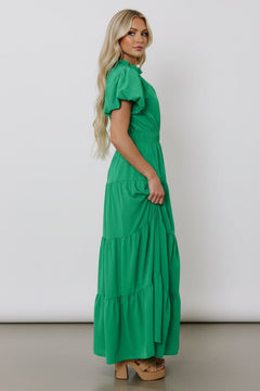 Green tiered maxi dress with short puff sleeves and gathered waist, side drape