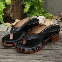 Black toe-post block-heel sandals with wide thong straps and stitched platform sole.