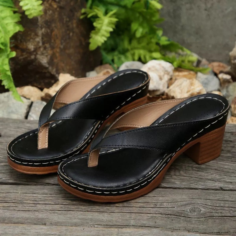 Black toe-post block-heel sandals with wide thong straps and stitched platform sole.