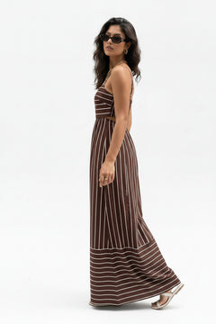 Brown striped maxi dress with spaghetti straps, side view, wavy stripe border at hem