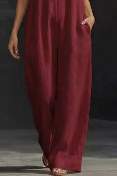 Burgundy sleeveless wide-leg jumpsuit with relaxed, flowy wide trouser legs