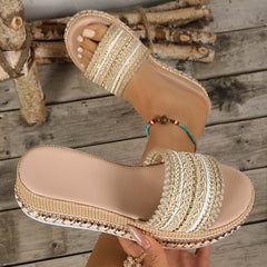 Khaki open-toe platform sandal shown in hand, braided strap with beaded accents