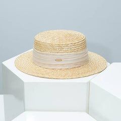 Straw boater hat with light cream ribbon band and beige woven brim