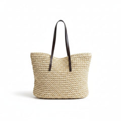 Woven straw tote bag, khaki woven straw with brown handles, side view open top.