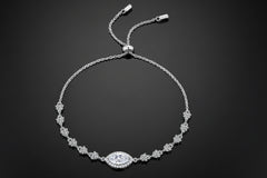 Silver bracelet with a central clasp on a light gray background