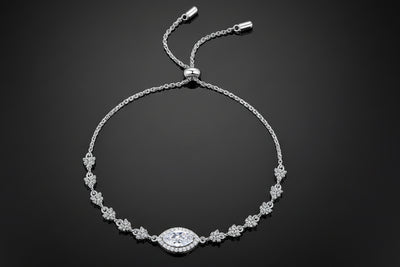Silver bracelet with a central clasp on a light gray background