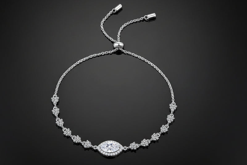 Silver bracelet with a central clasp on a light gray background