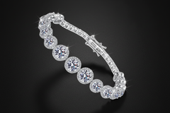 Silver bracelet with clear gemstones on a light grey background