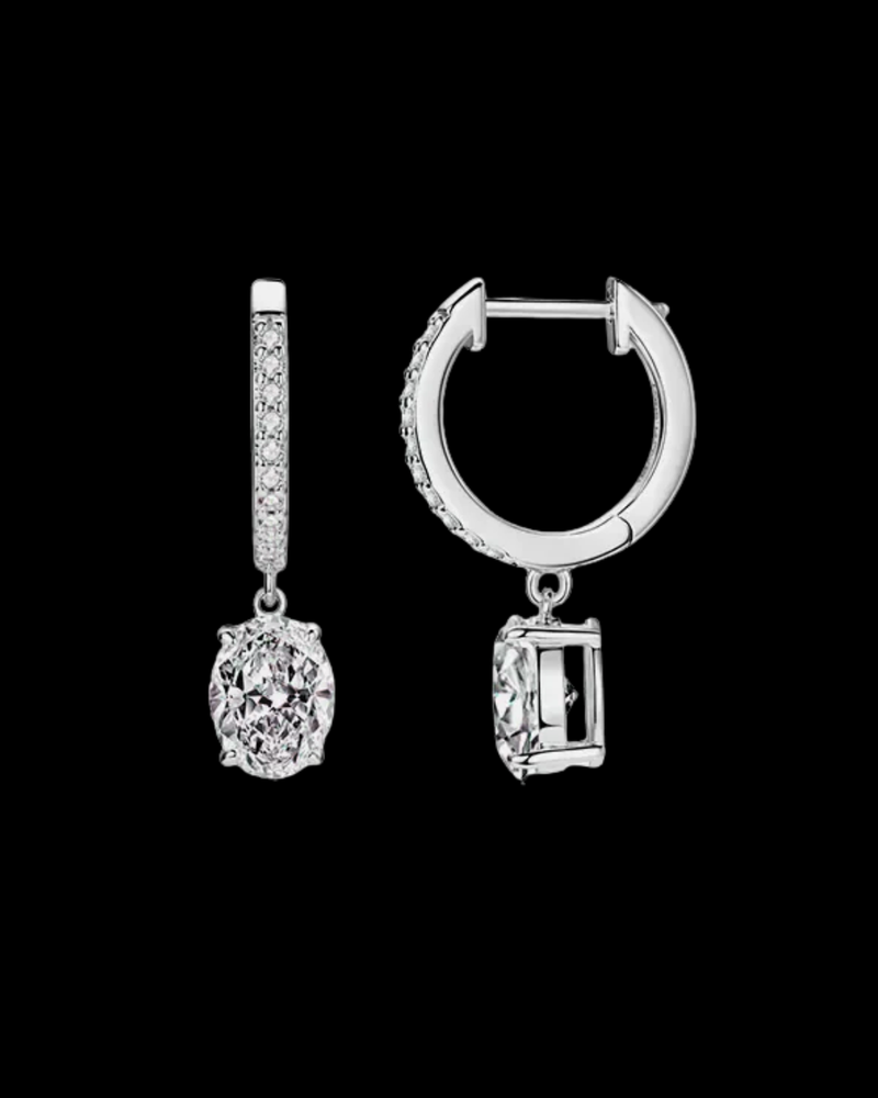 Pair of silver earrings with gemstone-like pendants on a black background
