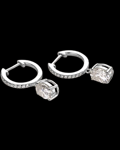 Pair of silver hoop earrings with clear gemstones on a black background