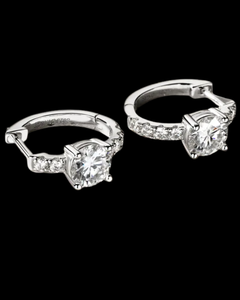 Pair of silver hoop earrings with clear gemstones on a black background