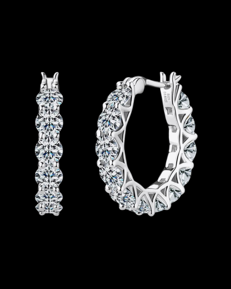Pair of silver hoop earrings on a black background